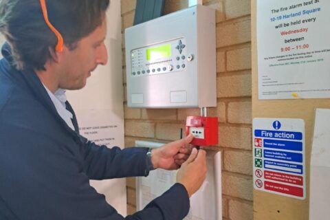 Man testing a fire panel
