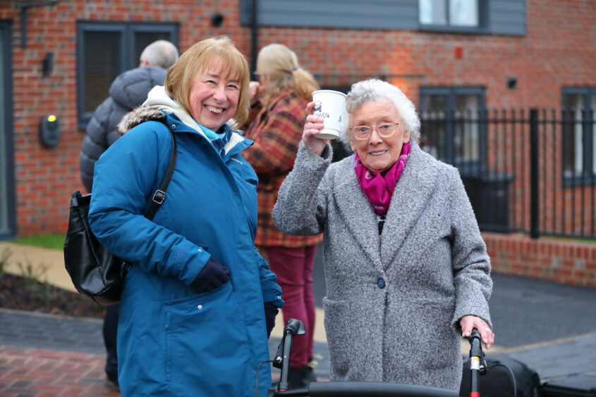 Our Chair and a customer stood next to each other
