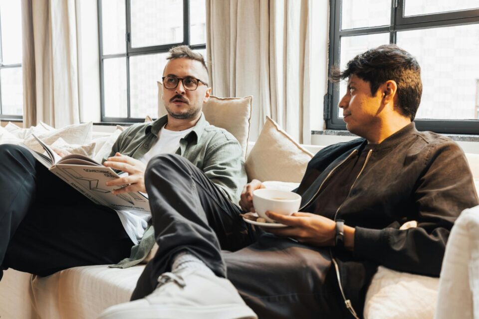 Two people talking on a sofa