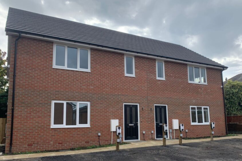 Red bricked new build semi-detached home. Each home has a tarmac drive in front of it