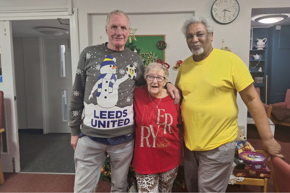 People stood together in Christmas jumpers