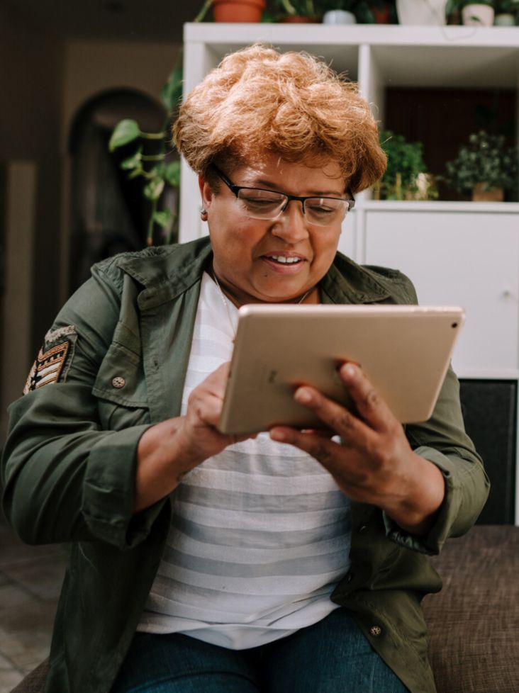 Woman looking at her tablet and smiling