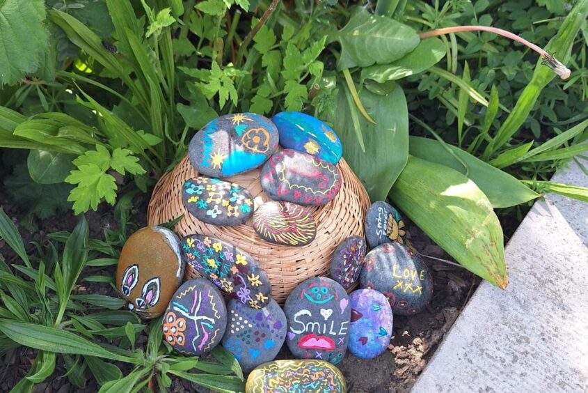Painted pebbles in a pile