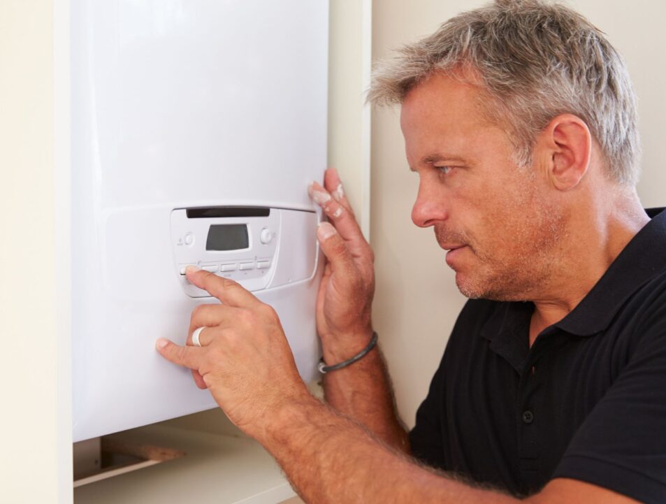 Man repairing a boiler in a customer's home