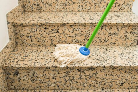 Mopping stone stairs in a communal area