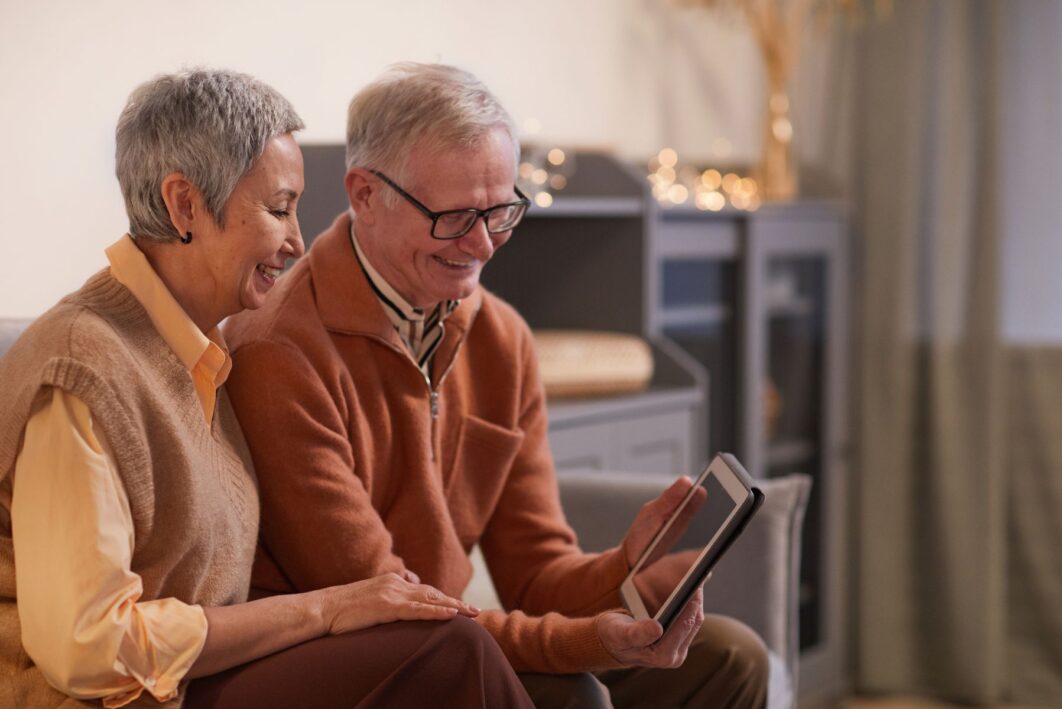 A couple looking at an electronic tablet.