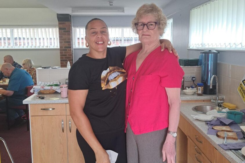 Two people stood in front of a camera