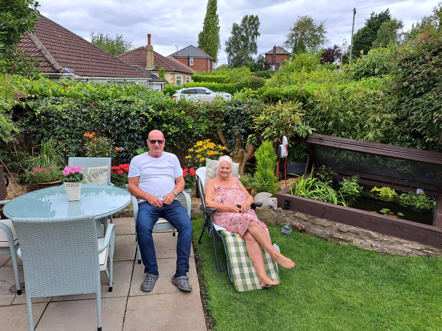 Mr and Mrs Beecroft sat on their deck chairs in their lovely garden.