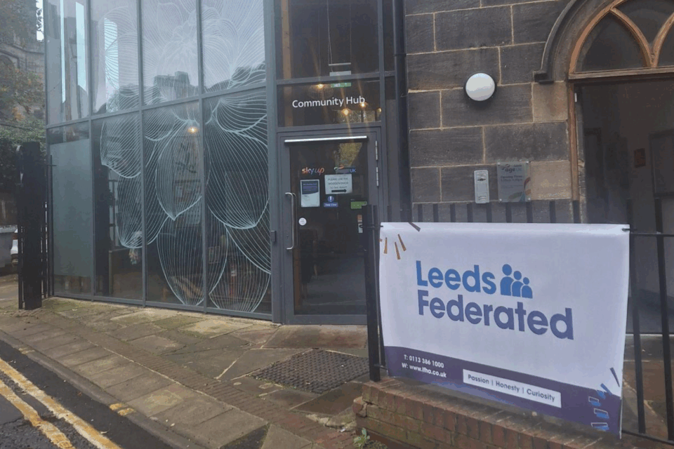 Entrance to our Housing Hub building. There's a banner with our logo on the railings outside.