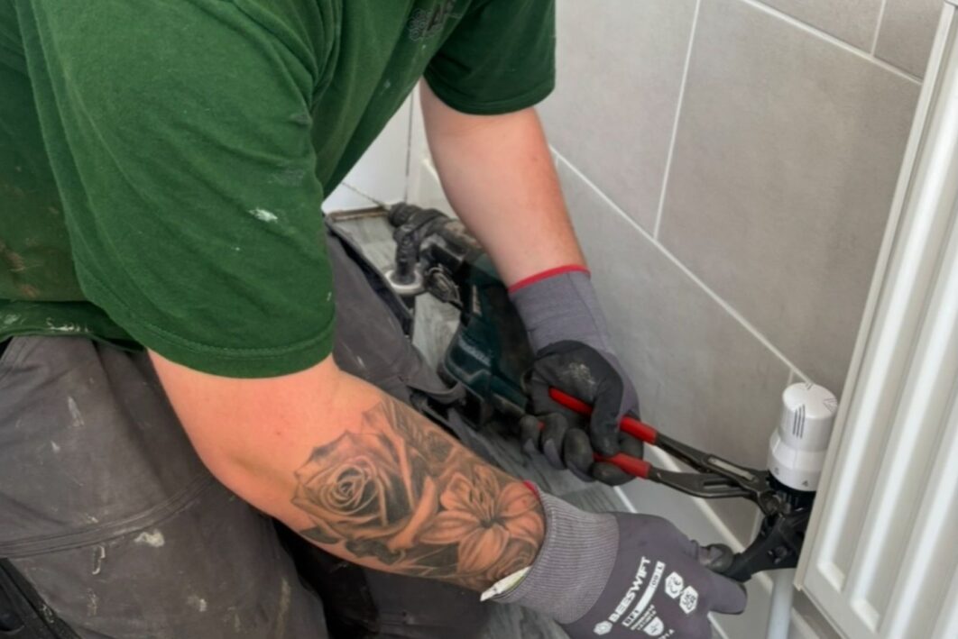 Person twisting the valve off a radiator