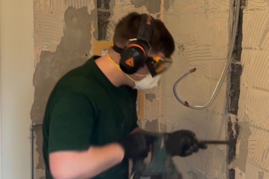 Person drilling into a pipe