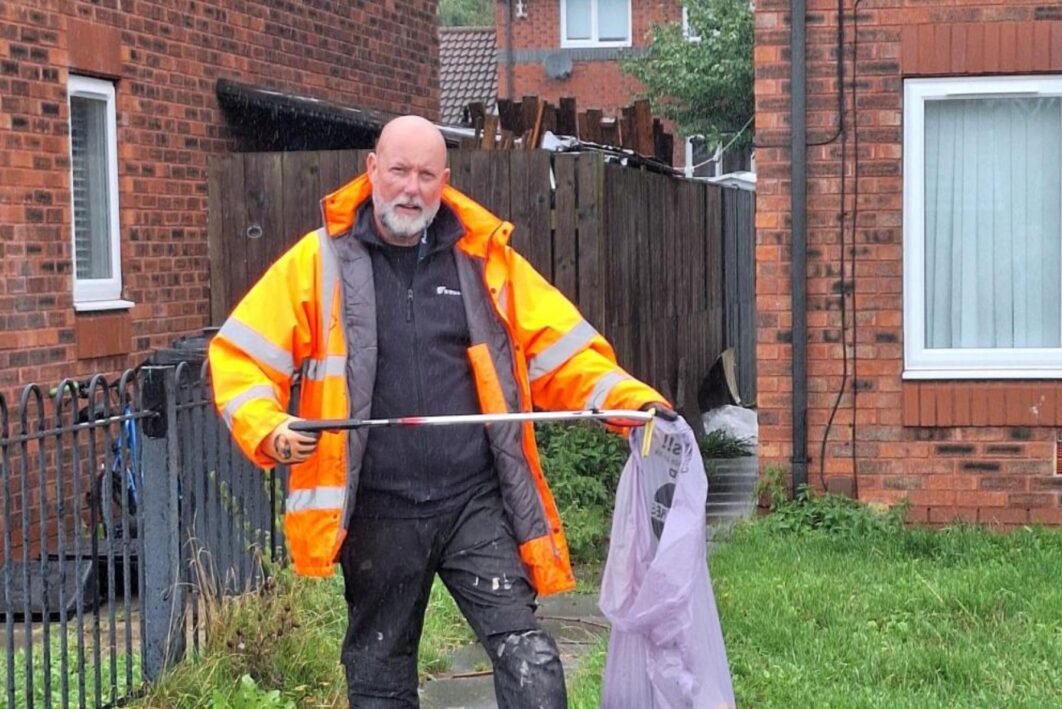 man litter picking in a front garden
