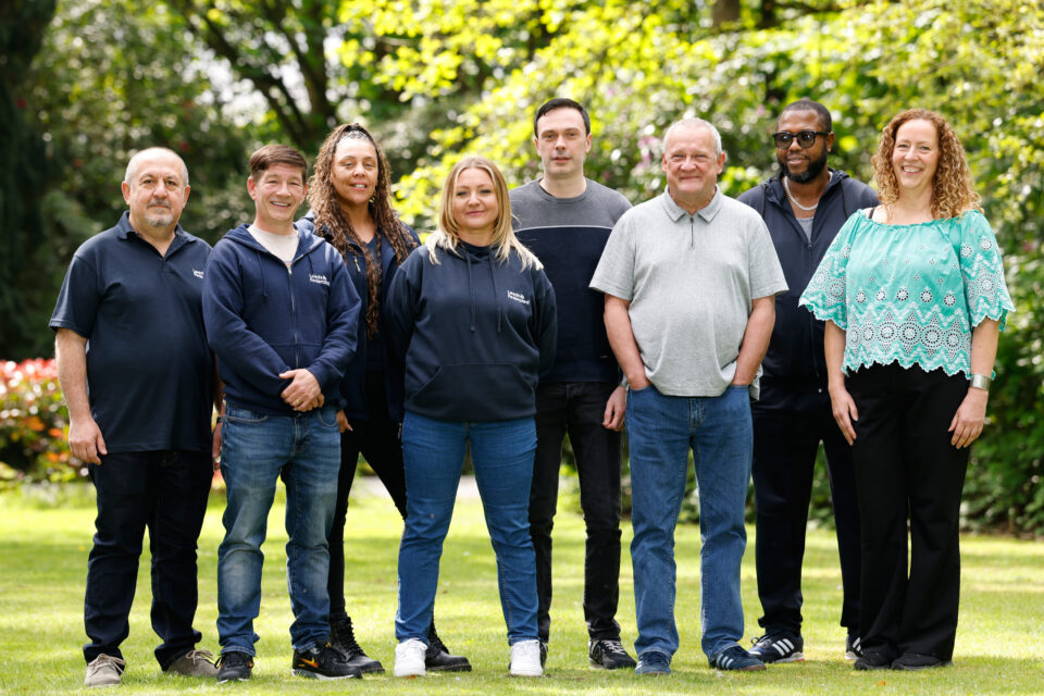 Colleagues from the South team standing outside in a row, smiling