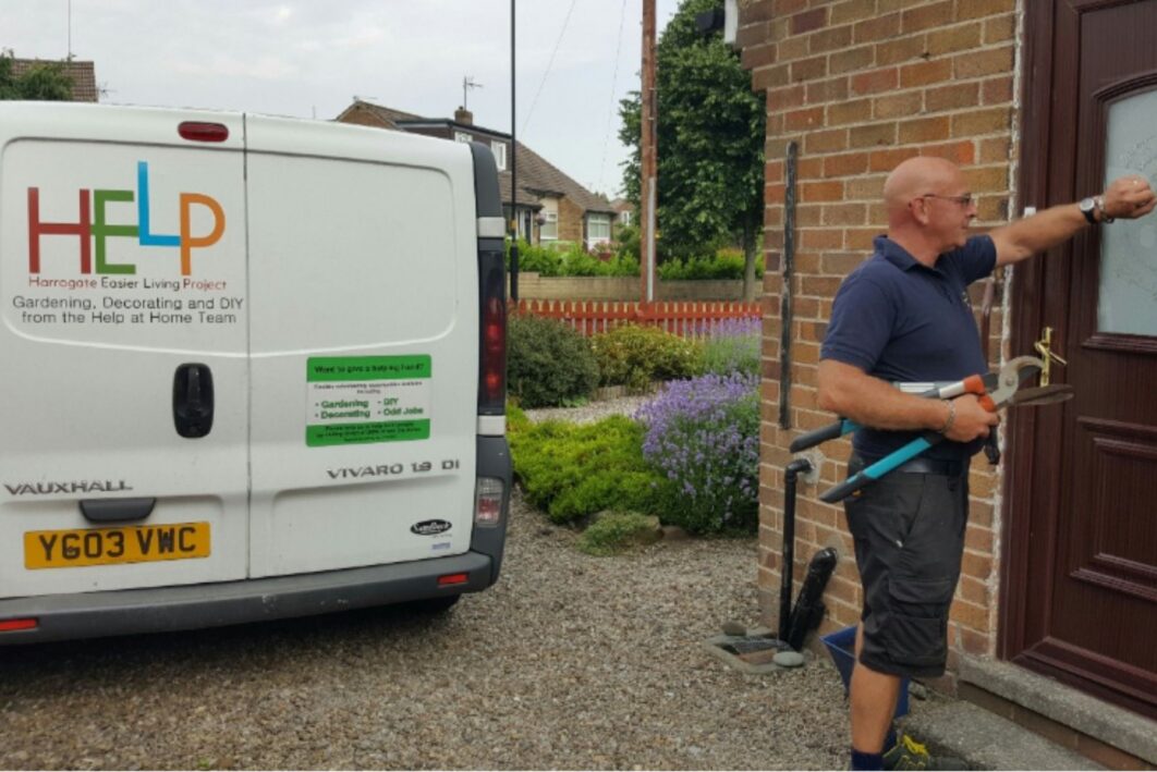 Man knocking on front door with a van next to him
